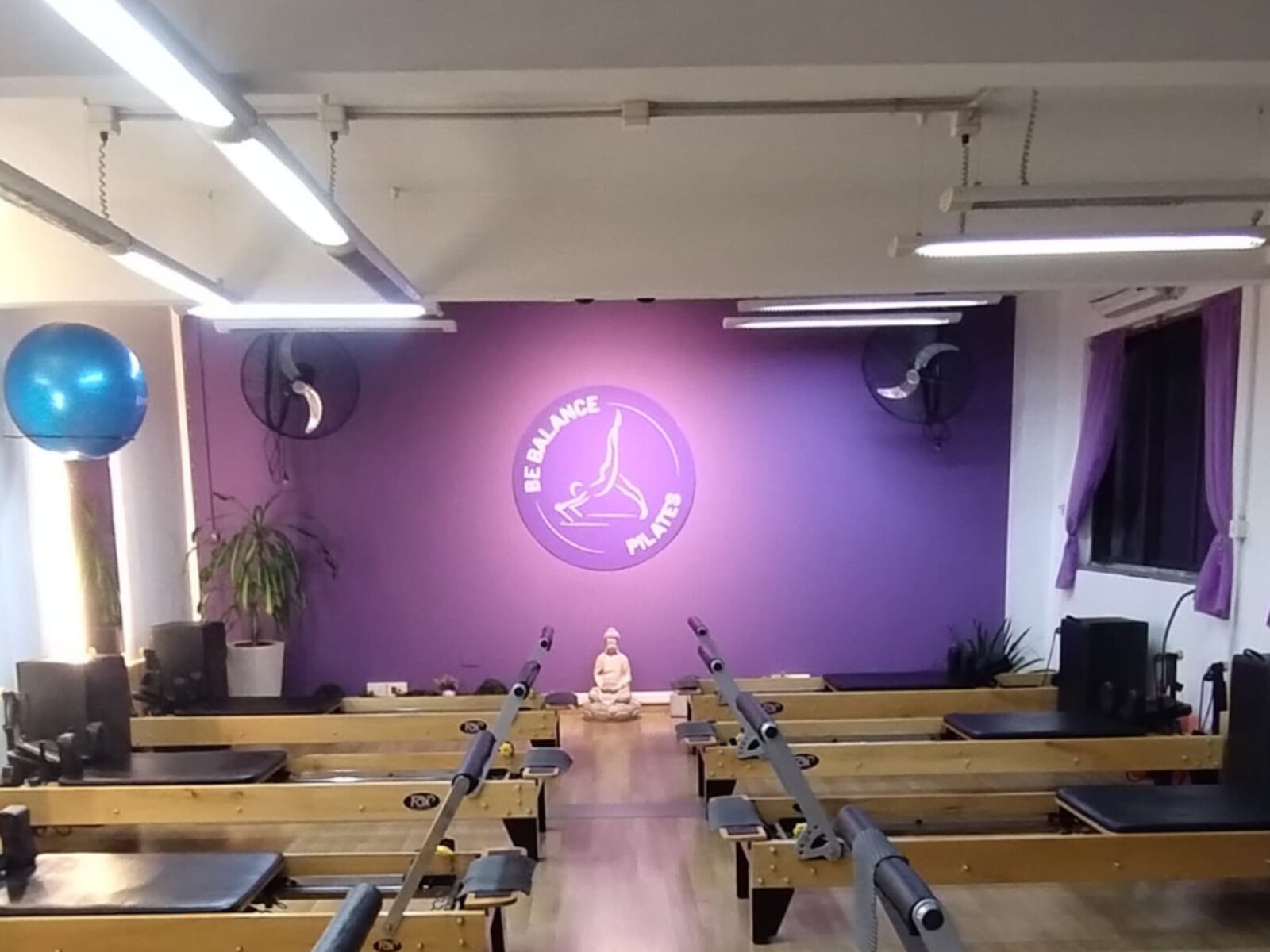 Interior del estudio Be Balance en San Telmo con pared violeta, reformers y estatua de Buda